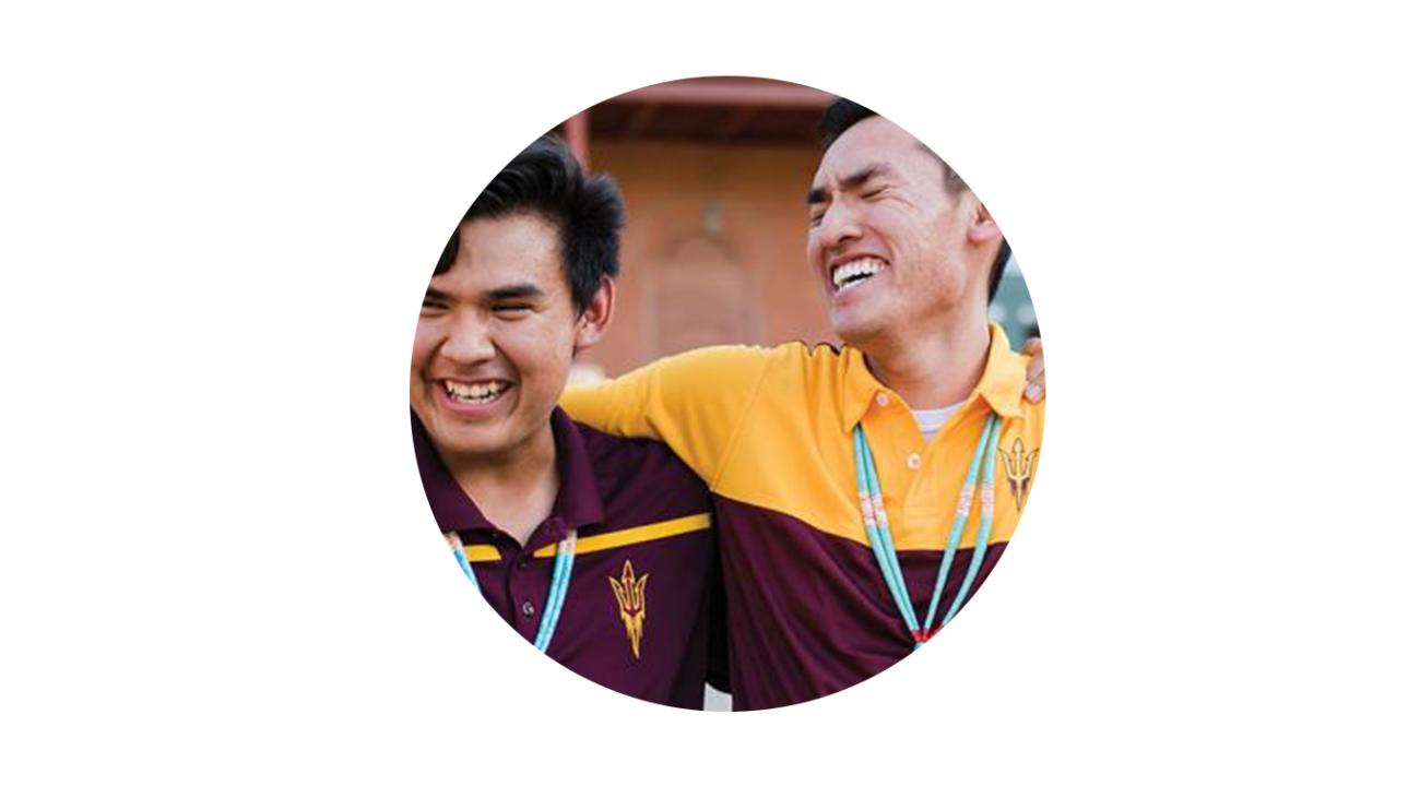 Two Center for Indian Education members laugh together.
