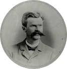 Circular black and white photo of John Armstrong with a mustache