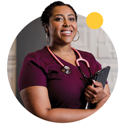 An ASU graduate wears scrubs and a stethoscope. 